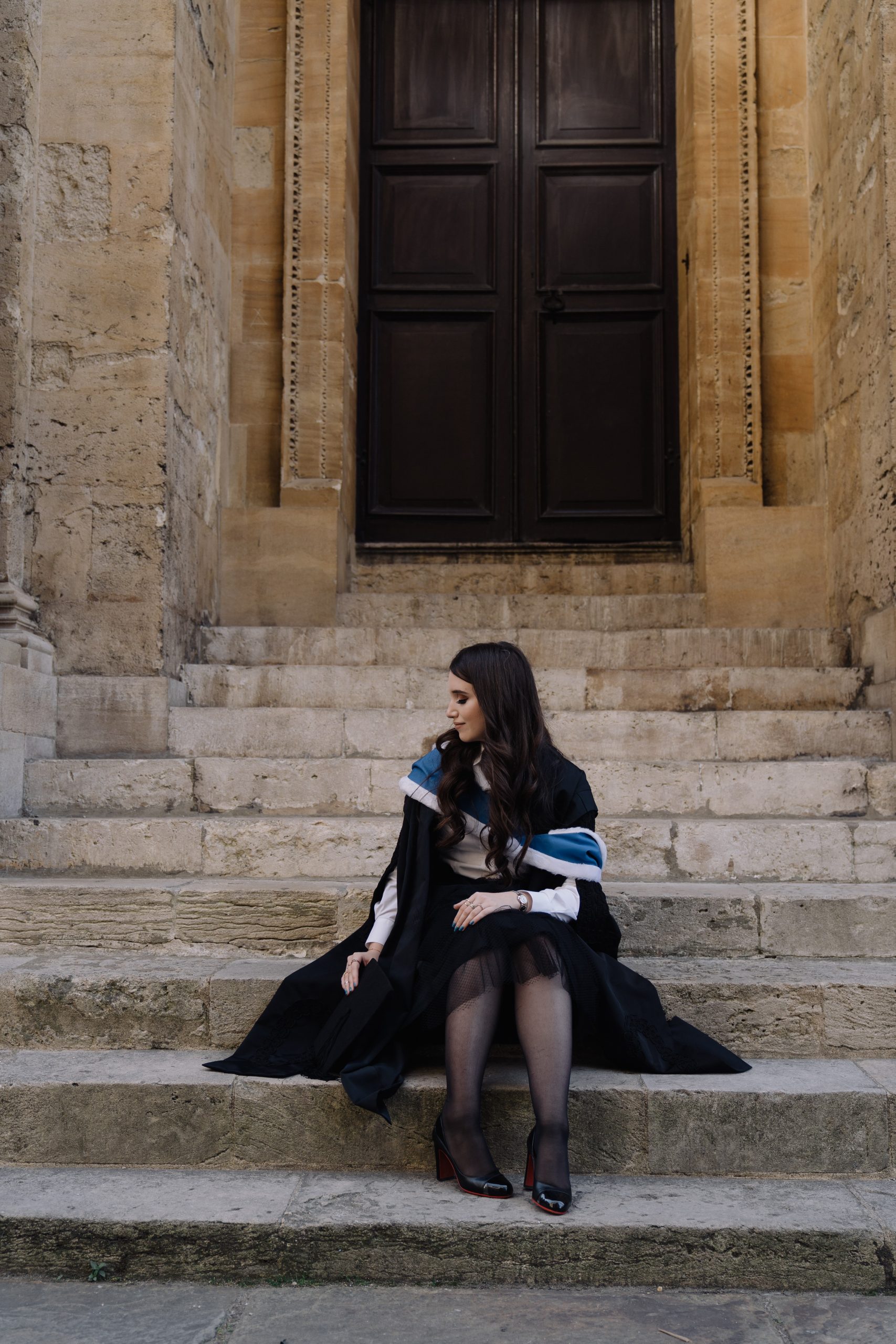 Anna seated at graduation