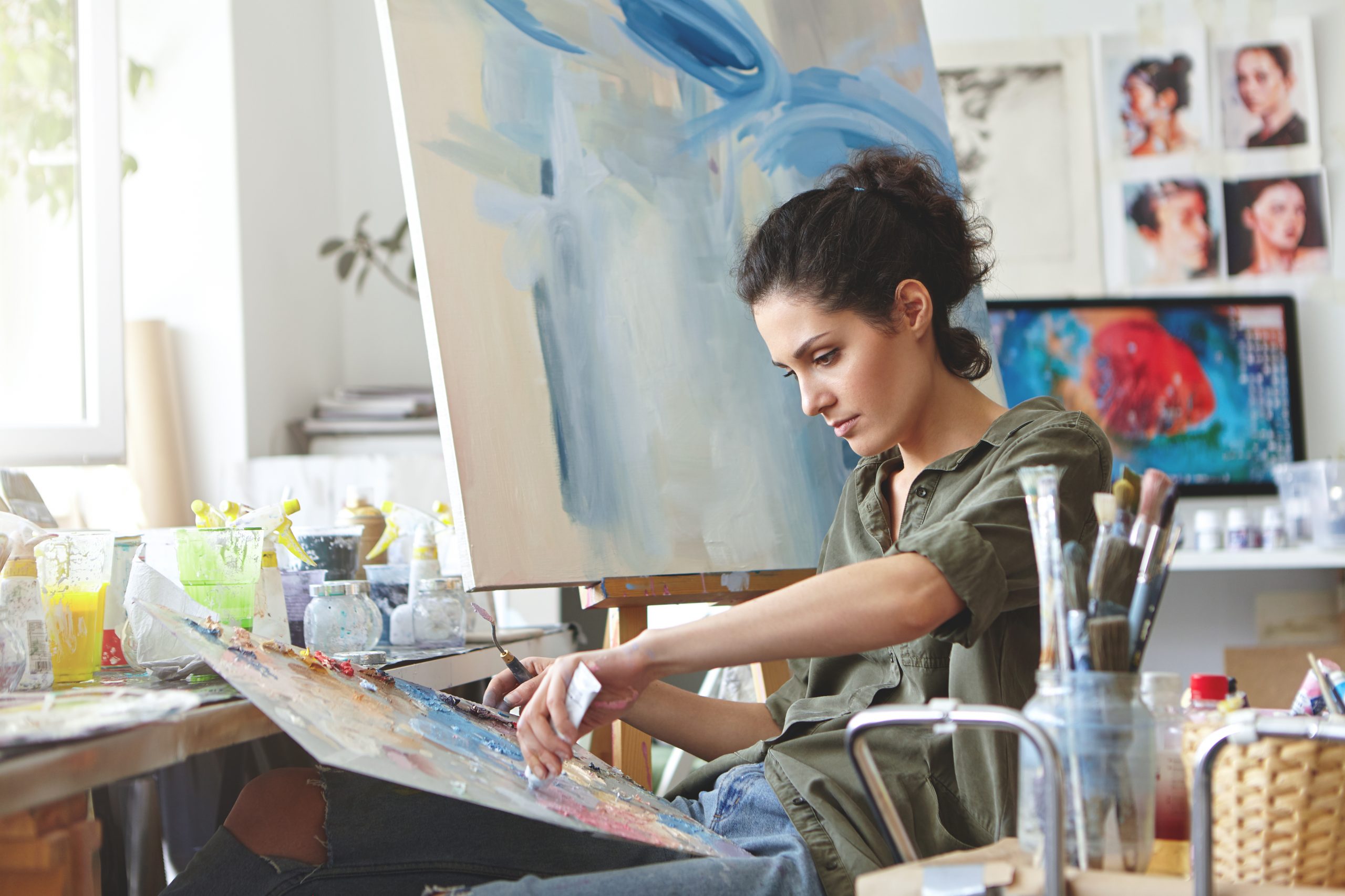 Young female student having classes at art studio